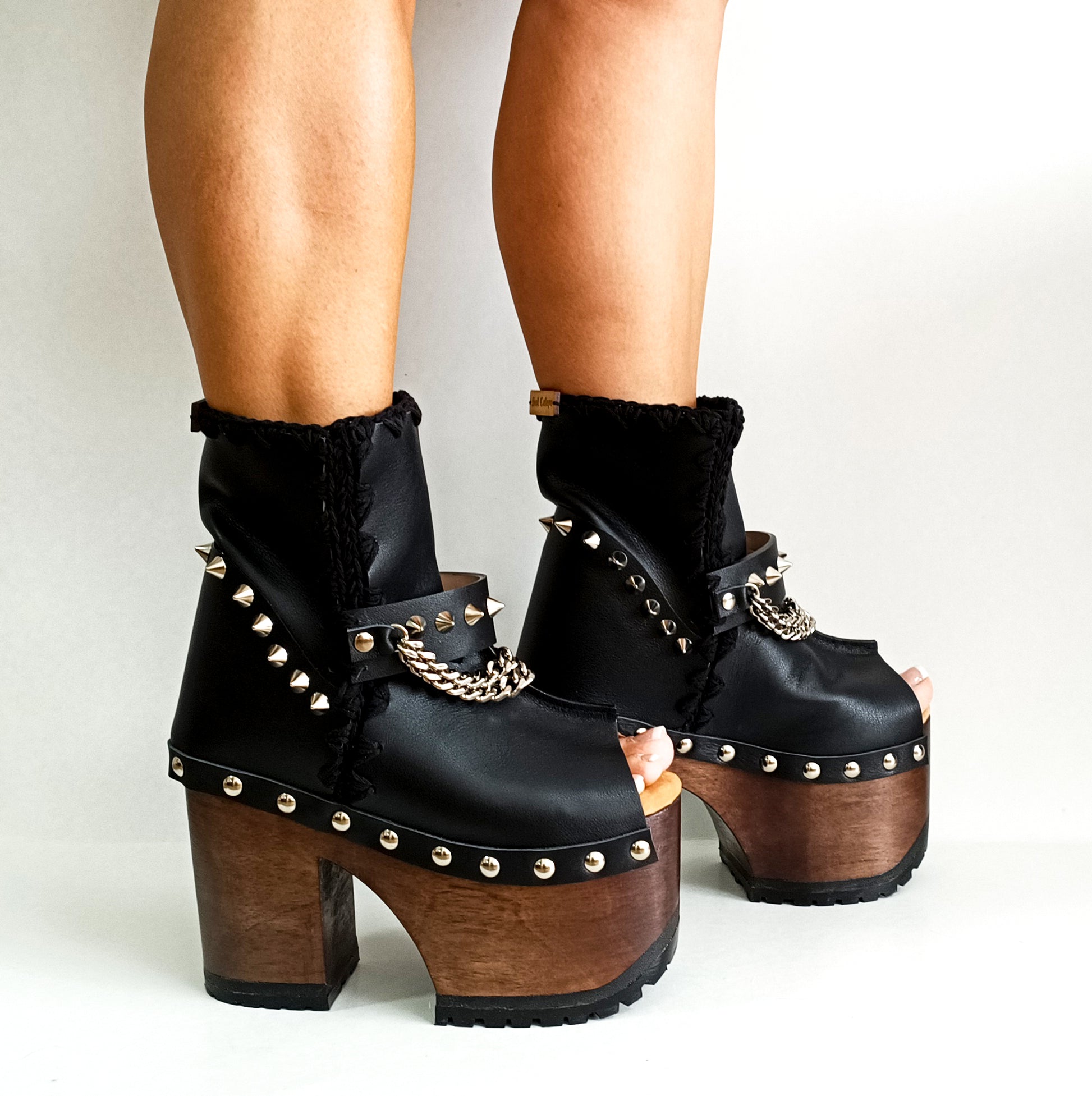 Black leather platform boot. Leather boot with super high wooden heel. Leather peep toe boot decorated with studs and silver chains. Platform boots with platform heel. Sizes 34 to 47. High quality leather shoes handmade by sol Caleyo. Sustainable fashion.