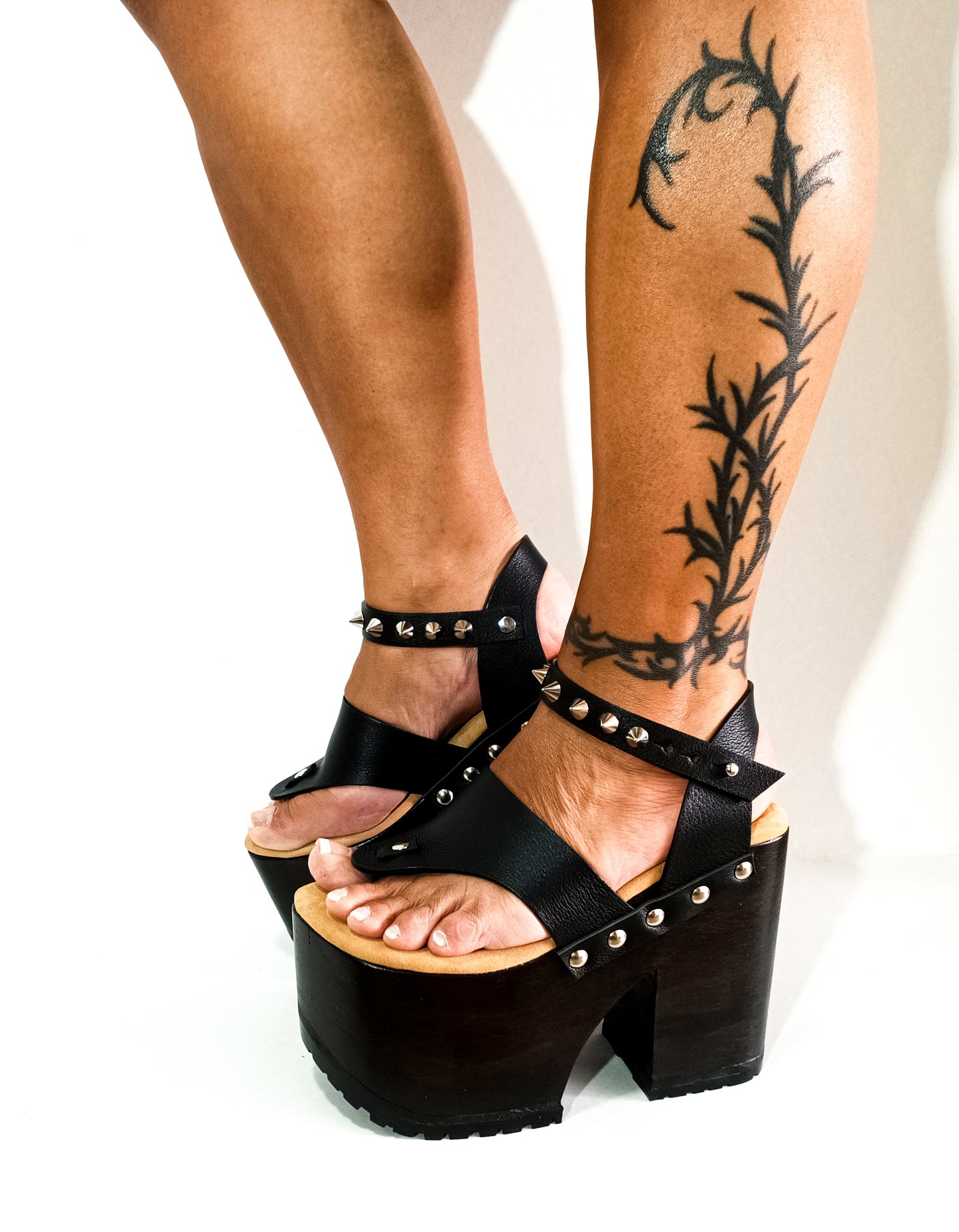 Flip flop style platform sandal. Flip flop style clog sandal. Black flip flop style sandal with silver studs. Black leather flip flop style wooden heel with silver studs. Sizes 34 to 47. Handmade leather shoes by sol Caleyo.