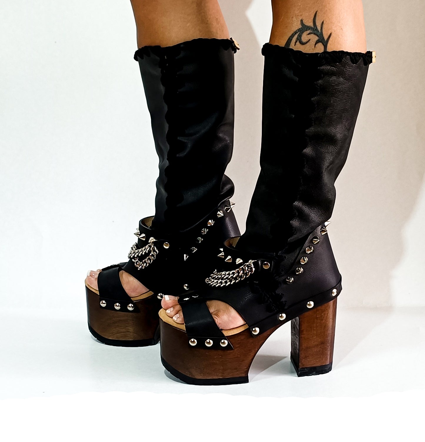 Black platform sandal with super high heel. Black super high heel platform boot with studs and silver chains. Super high heel biker style boot. Sizes 34 to 47. Handmade leather shoes by sol Caleyo.