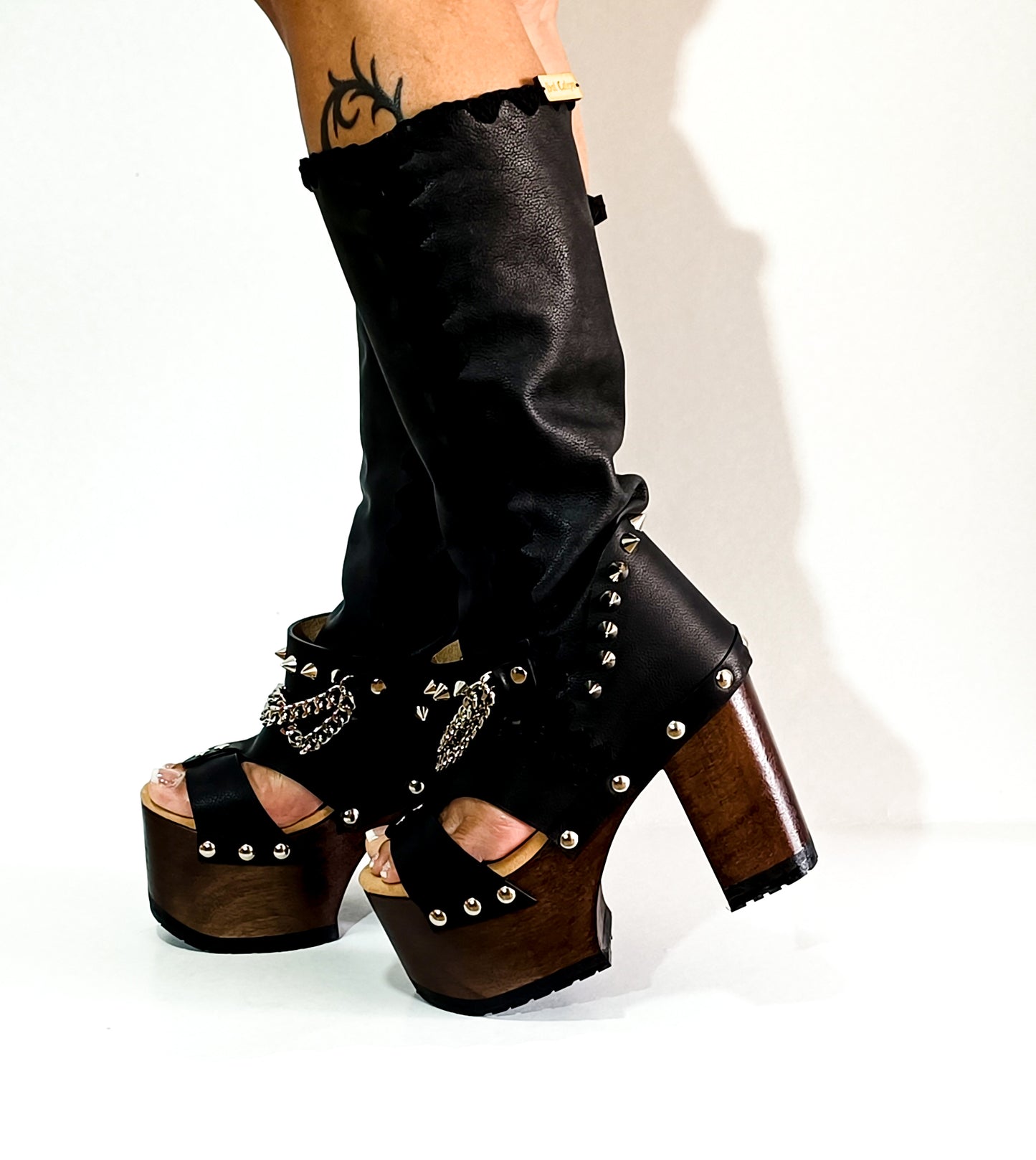 Black platform sandal with super high heel. Black super high heel platform boot with studs and silver chains. Super high heel biker style boot. Sizes 34 to 47. Handmade leather shoes by sol Caleyo.