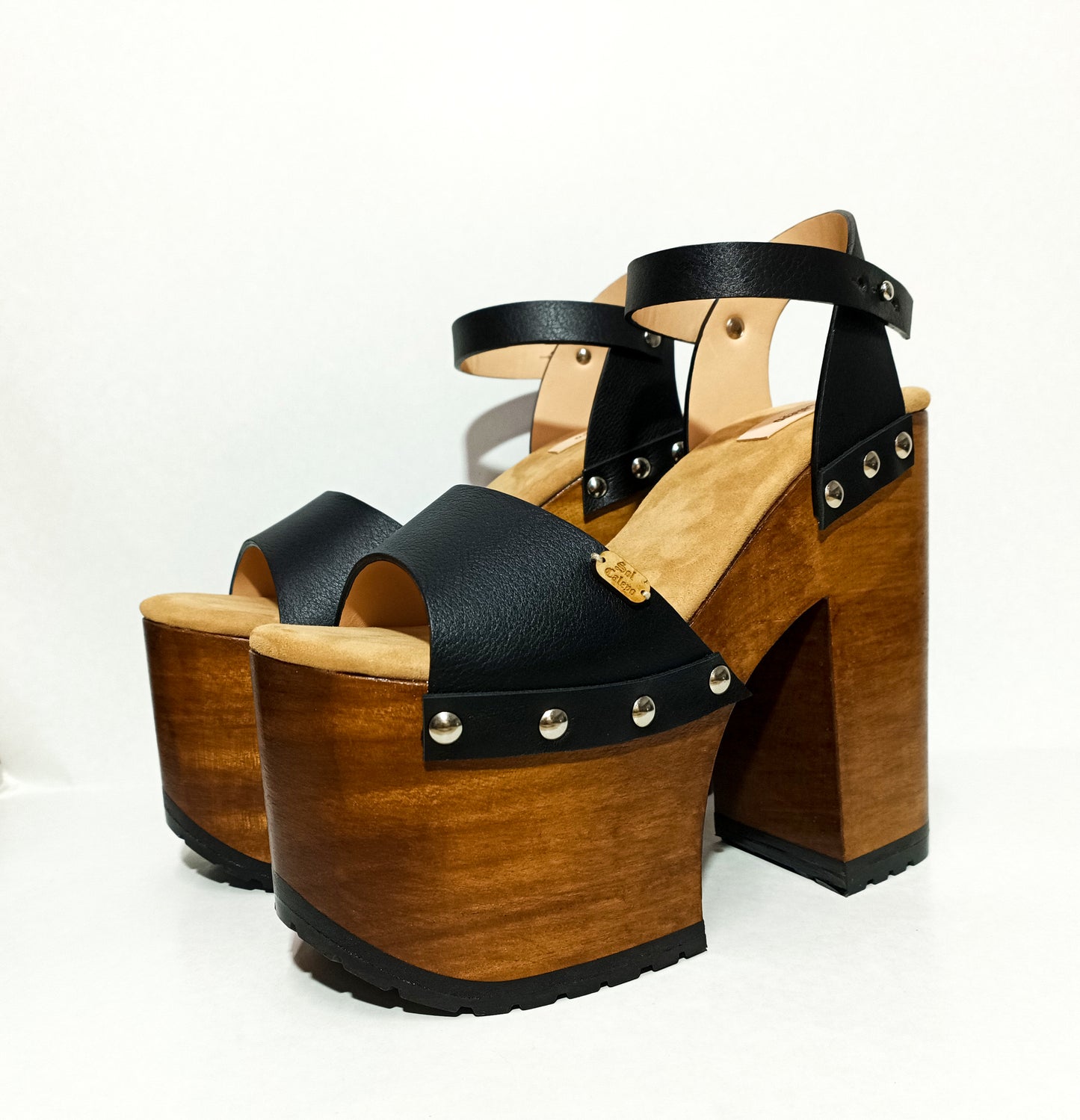 Vintage style platform sandals with super high wooden heels, made in leather. Sizes 34 to 47. Super high wooden heels inspired by the 70s. Exclusive handmade design. High quality footwear handmade by sol Caleyo.