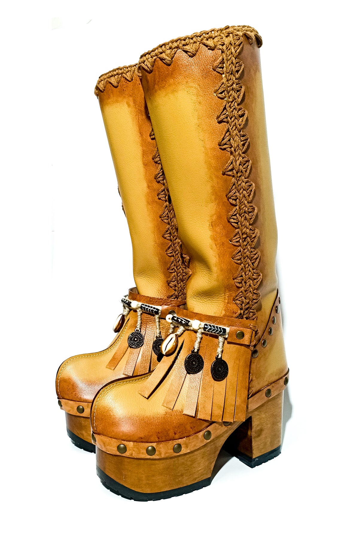 Beige leather boots on a hand shaped wooden platform