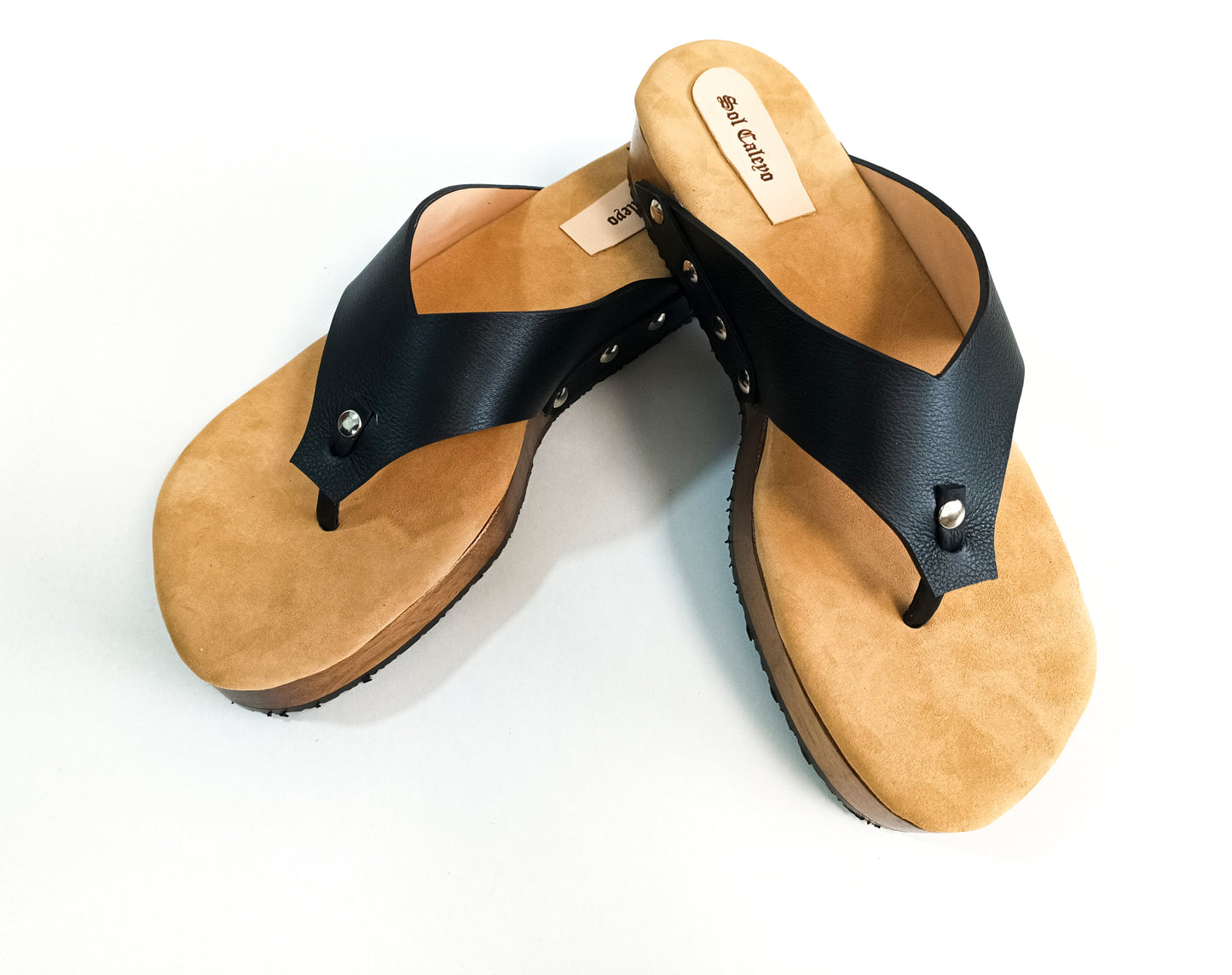 Black leather handcrafted men’s sandals with flat wooden sole and comfortable open clog design.