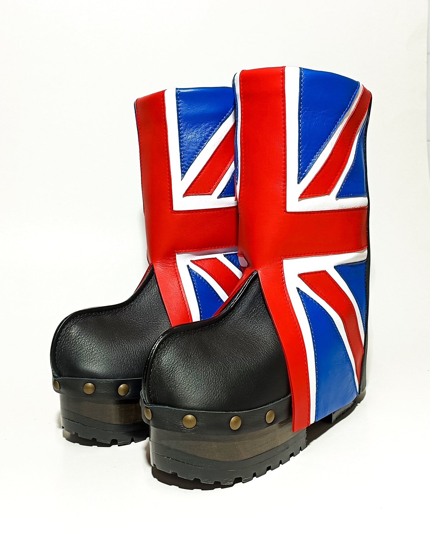 Detail of England flag leather upper and aged gold studs on handmade wooden sole platform boots.