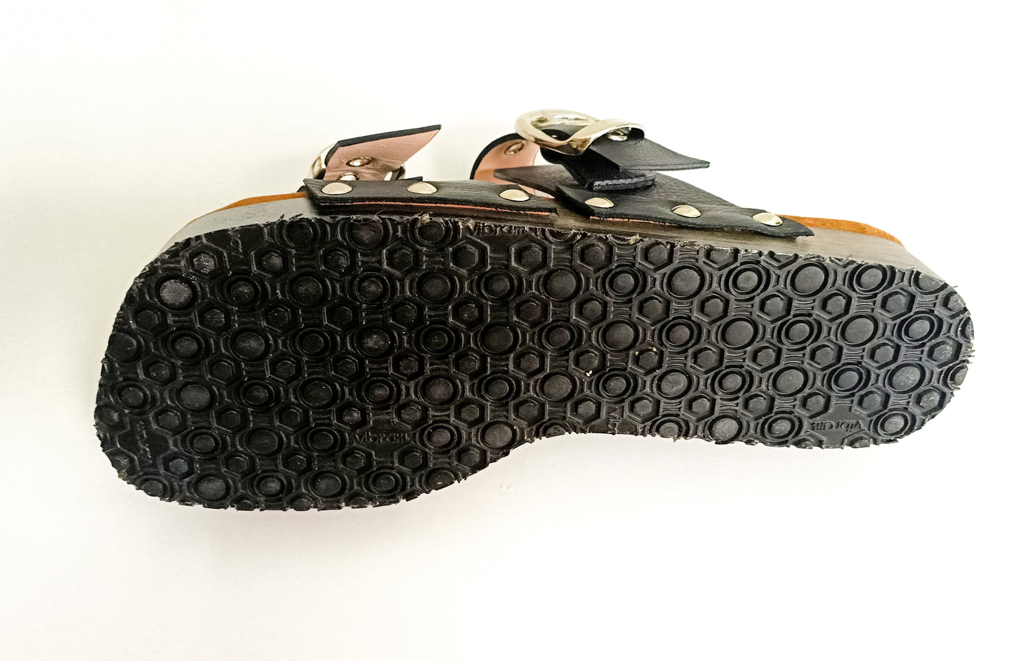 Wooden sole and black Vibram grip outsole on men’s handmade leather clog sandals.
