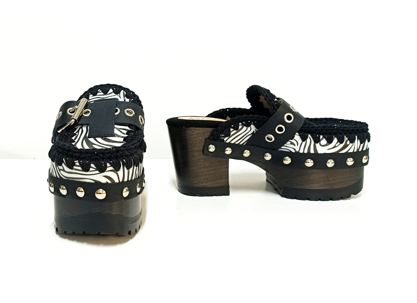 Zebra leather mules with wooden heels. Zebra clogs made from premium quality leather. High-end footwear handmade by Sol Caleyo.