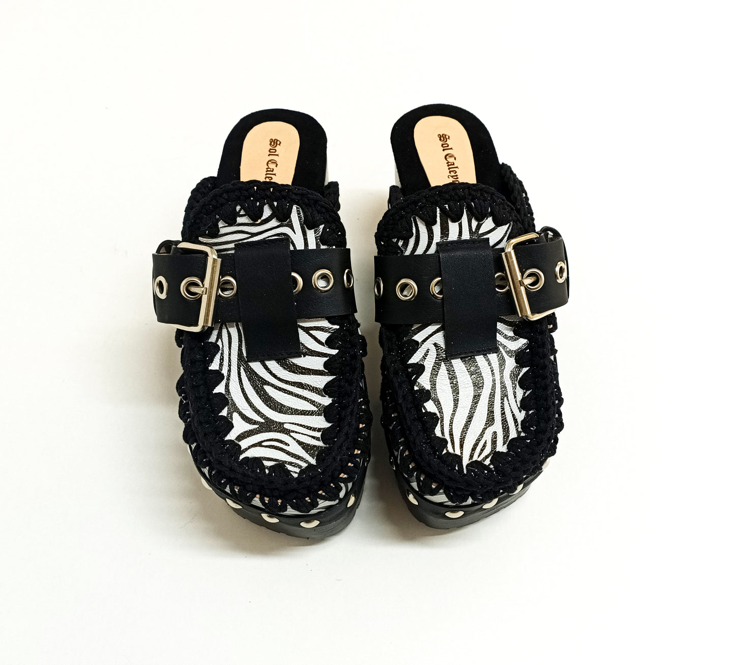 Zebra leather mules with wooden heels. Zebra clogs made from premium quality leather. High-end footwear handmade by Sol Caleyo.