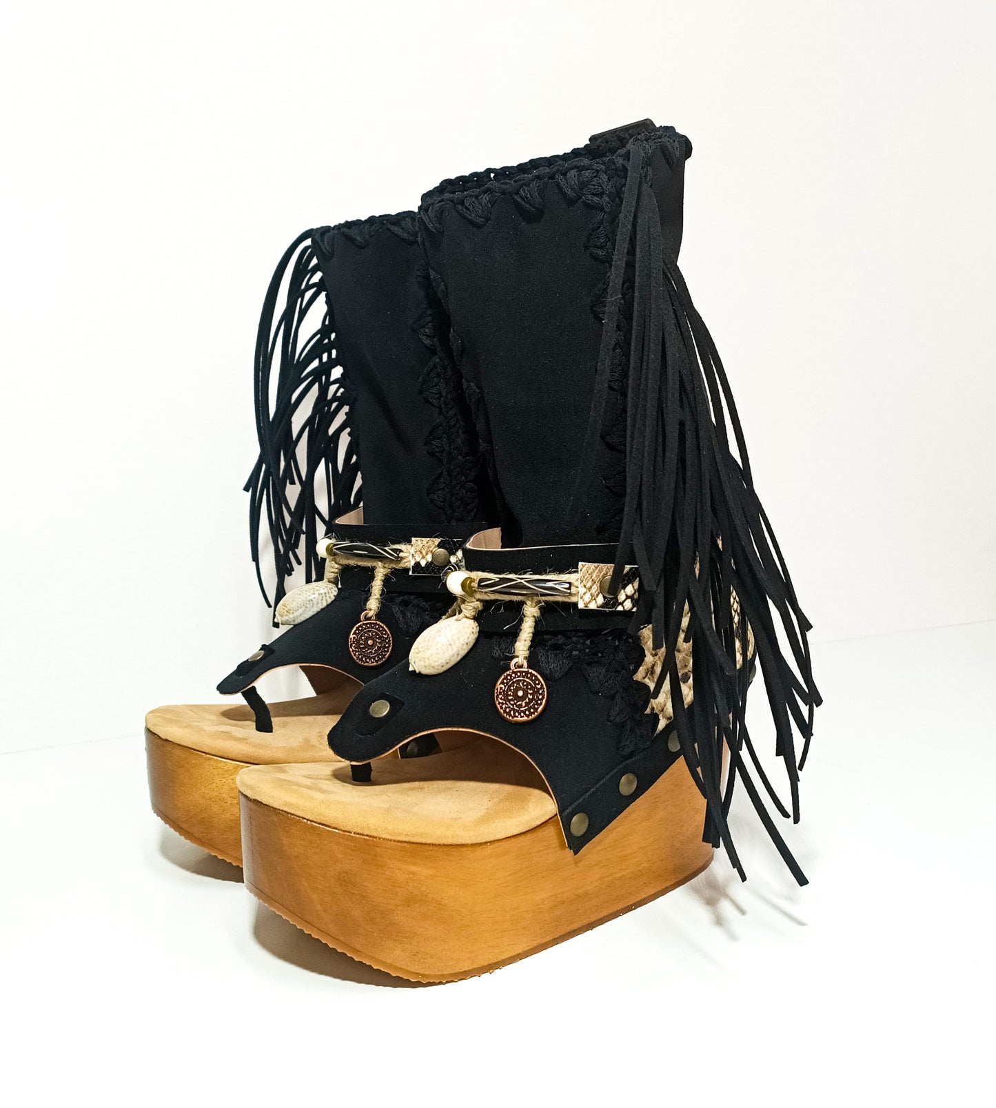 Leather clog boot with wooden wedge flip flop style. Leather flip flop style boot decorated with shells, coins and fringes which gives it an authentic Boho style. Leather flip flop with wooden wedge. Bohemian style leather boot. Sizes 34 to 47. High quality leather footwear handmade by sol Caleyo. Sustainable fashion.