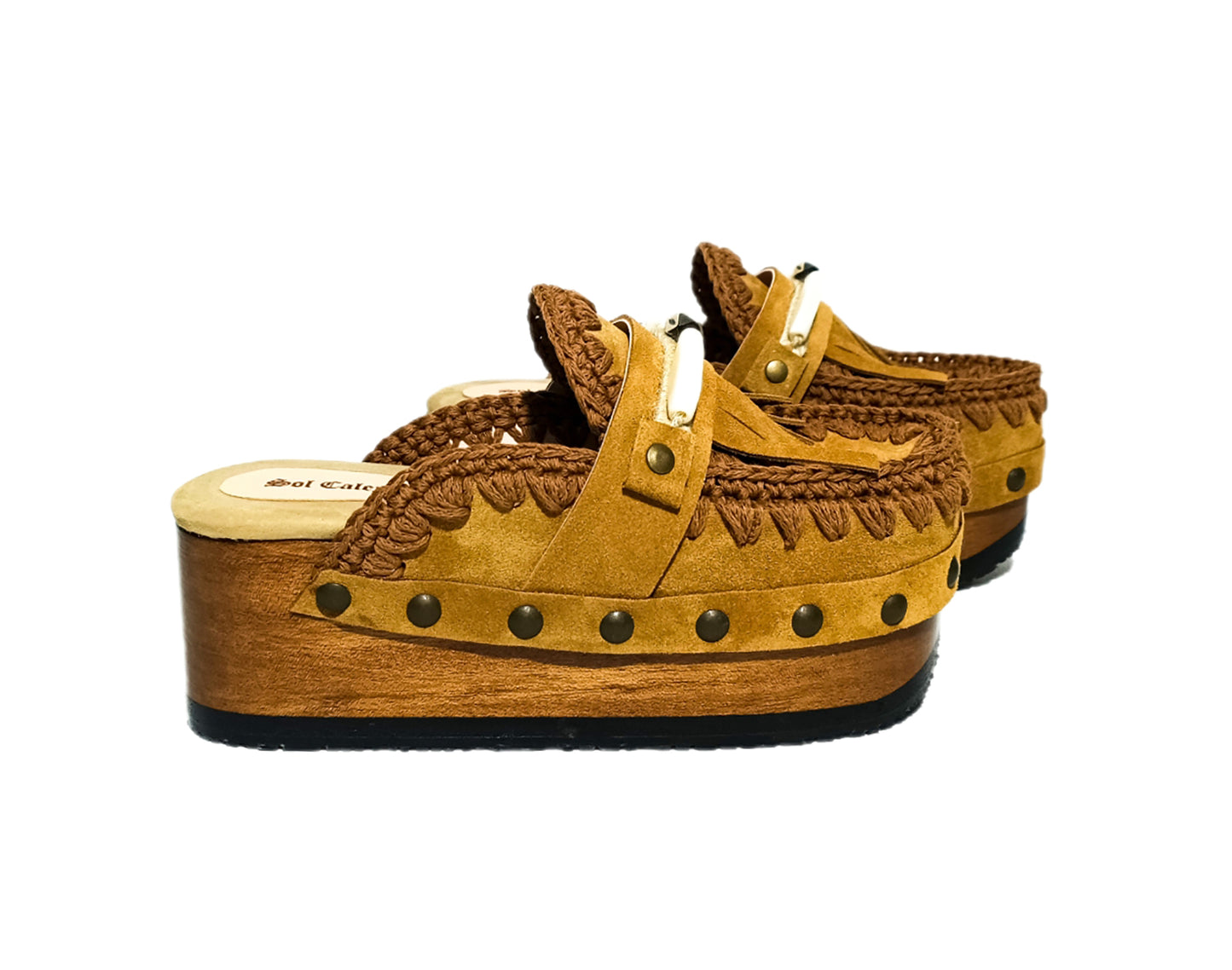 Moccasin style suede leather clogs, decorated with fringes and horns. Moccasin style leather mules. High-end footwear handmade by Sol Caleyo.
