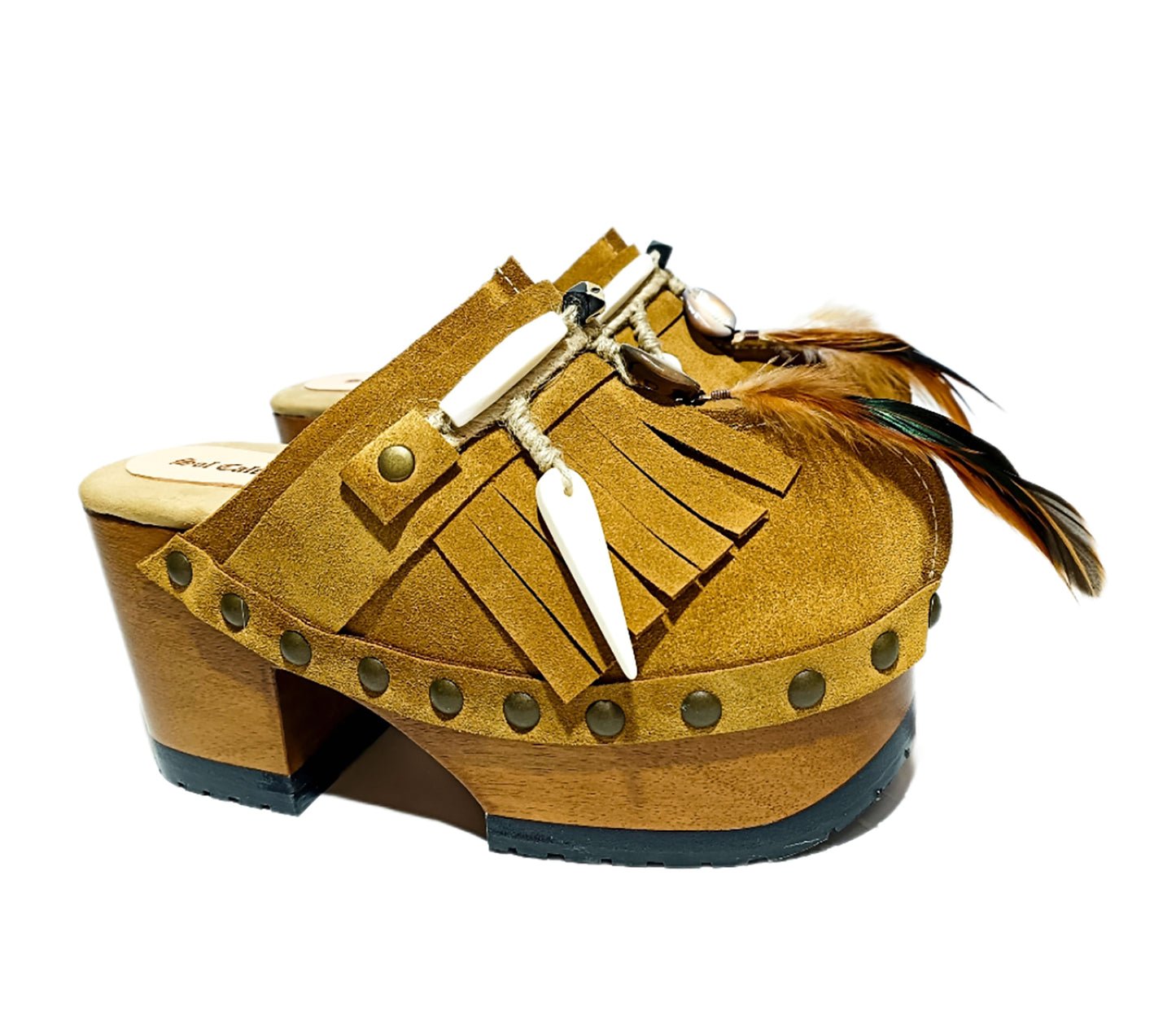 Bohemian style clogs, natural shell accessories, leather clogs decorated with feathers and natural shells. Boho style leather clogs. High-end handmade footwear by Sol Caleyo.