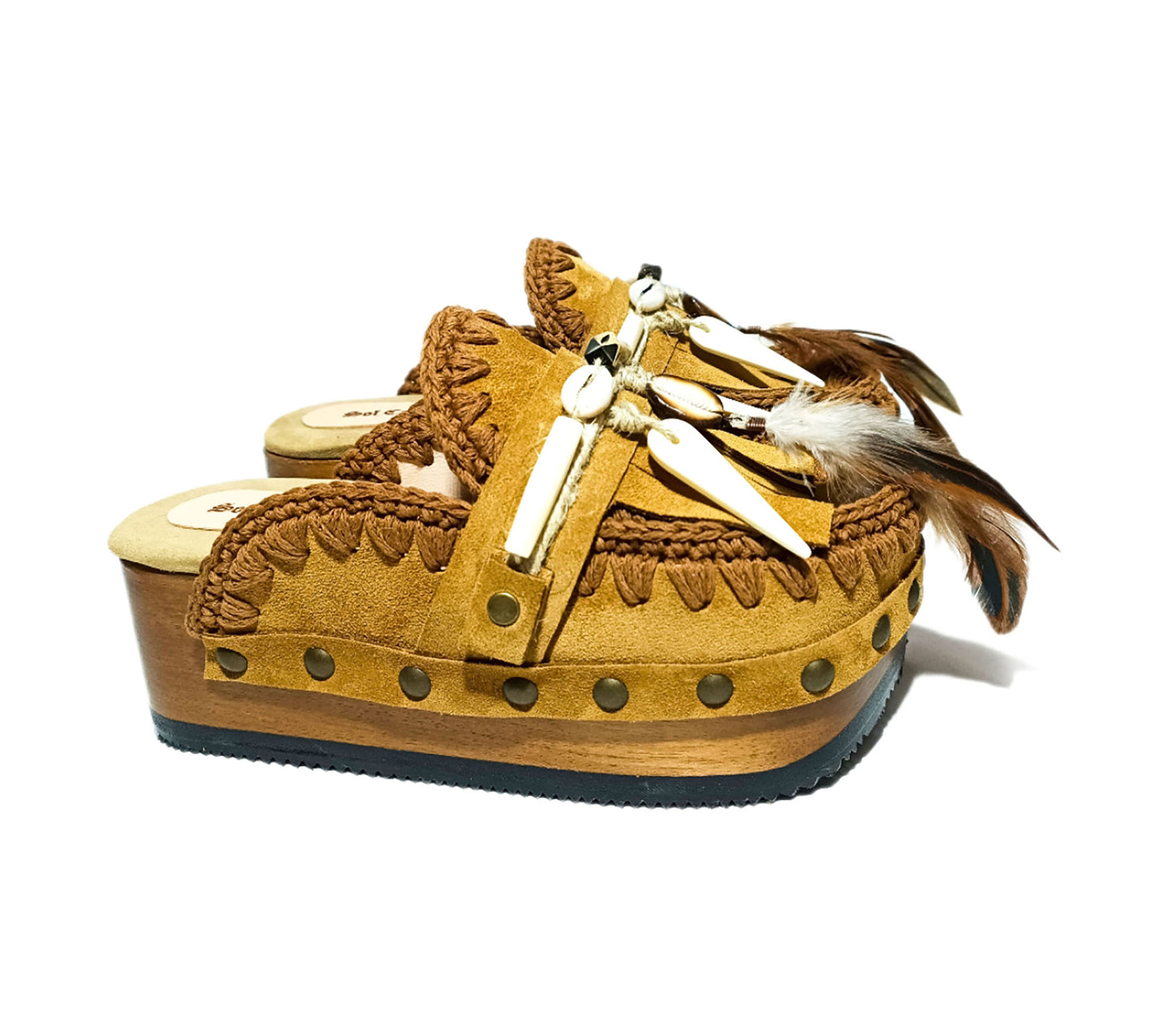 Moccasin style clogs, vintage style wooden wedge clogs. Bohemian style clogs, decorated with feathers, natural shells and horns. Moccasin clogs handmade by Sol Caleyo.