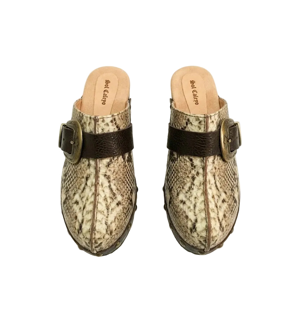 Handmade snake print leather clogs with brown leather strap and antique gold buckle on a wooden platform sole.