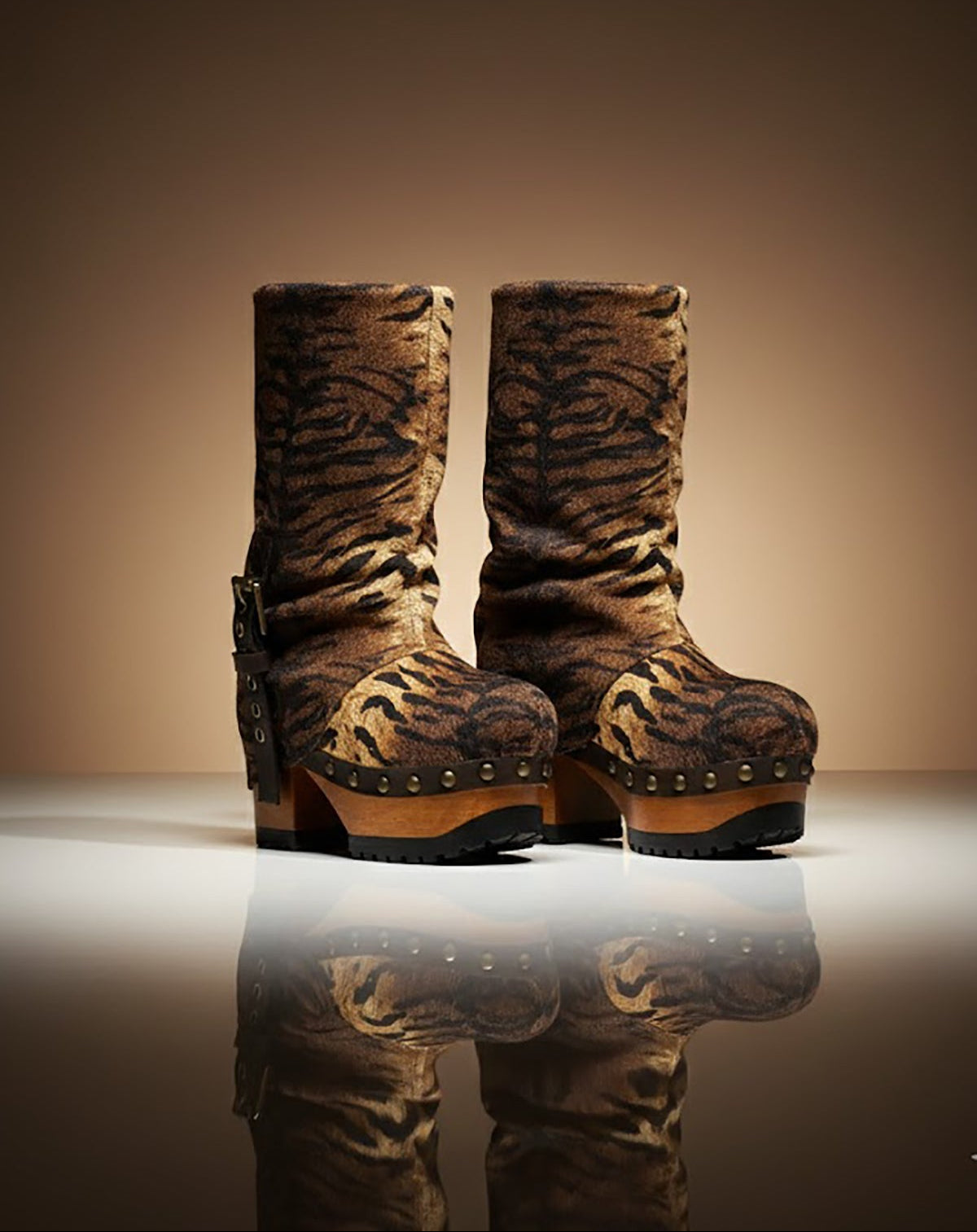 Sol Caleyo Tiger Boots - Handcrafted tiger-print suede boots with 3.5-inch wooden platform and antique gold buckle.