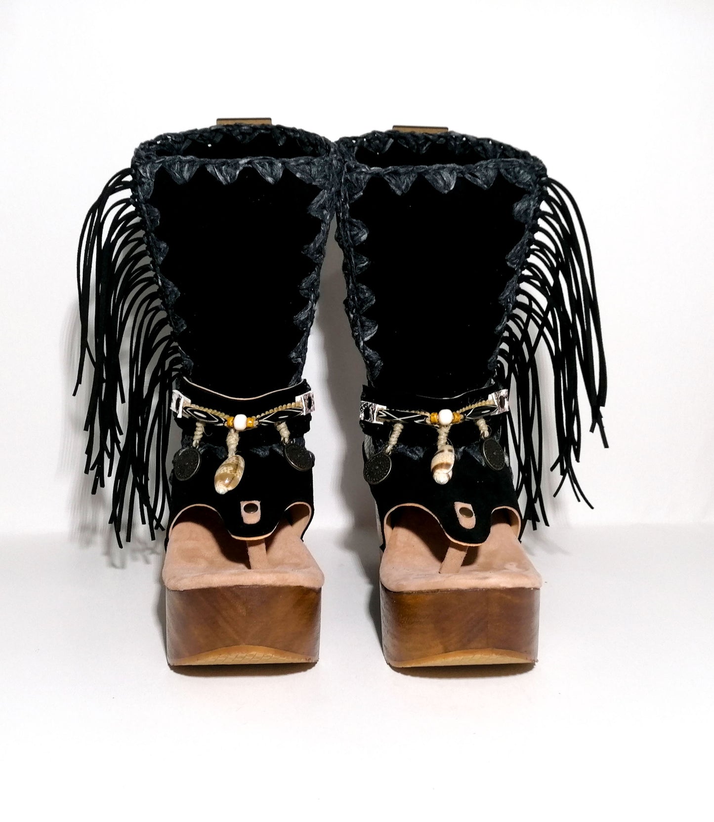 Leather clog boot with wooden wedge flip flop style. Leather flip flop style boot decorated with shells, coins and fringes which gives it an authentic Boho style. Leather flip flop with wooden wedge. Bohemian style leather boot. Sizes 34 to 47. High quality leather footwear handmade by sol Caleyo. Sustainable fashion.