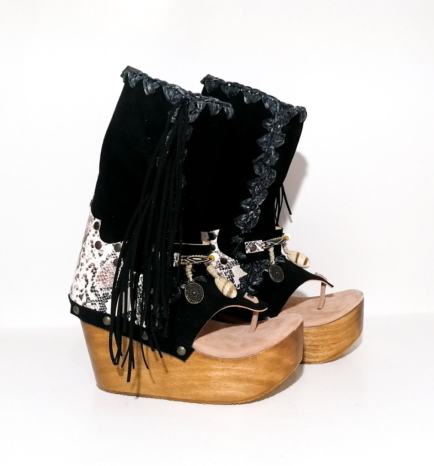 Leather clog boot with wooden wedge flip flop style. Leather flip flop style boot decorated with shells, coins and fringes which gives it an authentic Boho style. Leather flip flop with wooden wedge. Bohemian style leather boot. Sizes 34 to 47. High quality leather footwear handmade by sol Caleyo. Sustainable fashion.
