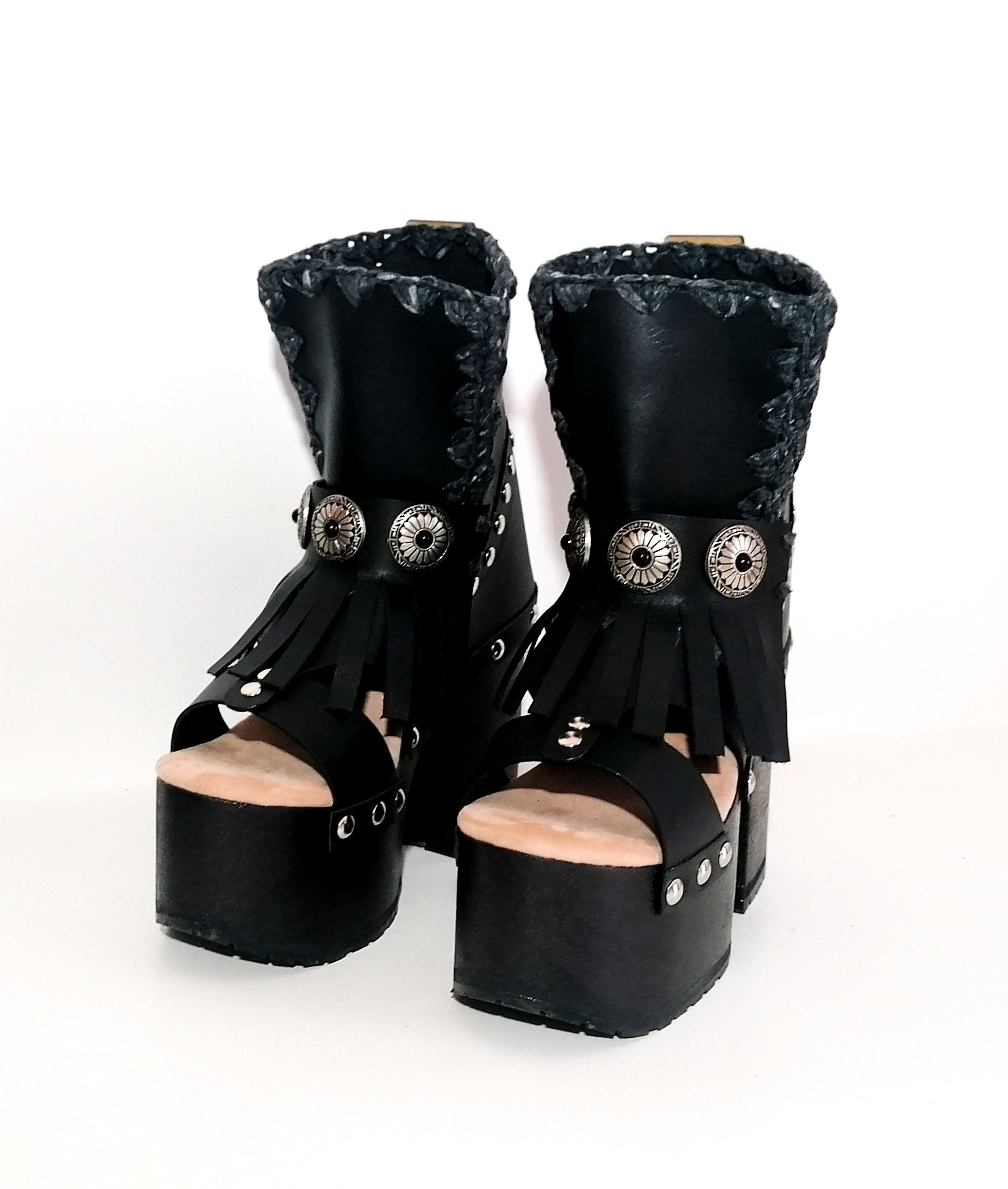 Black leather platform sandal. Leather boot with super high wooden heel. Black leather boot decorated with fringes and silver conchos. Bohemian style boots. Sizes 34 to 47. High quality leather shoes handmade by sol Caleyo. Sustainable fashion.