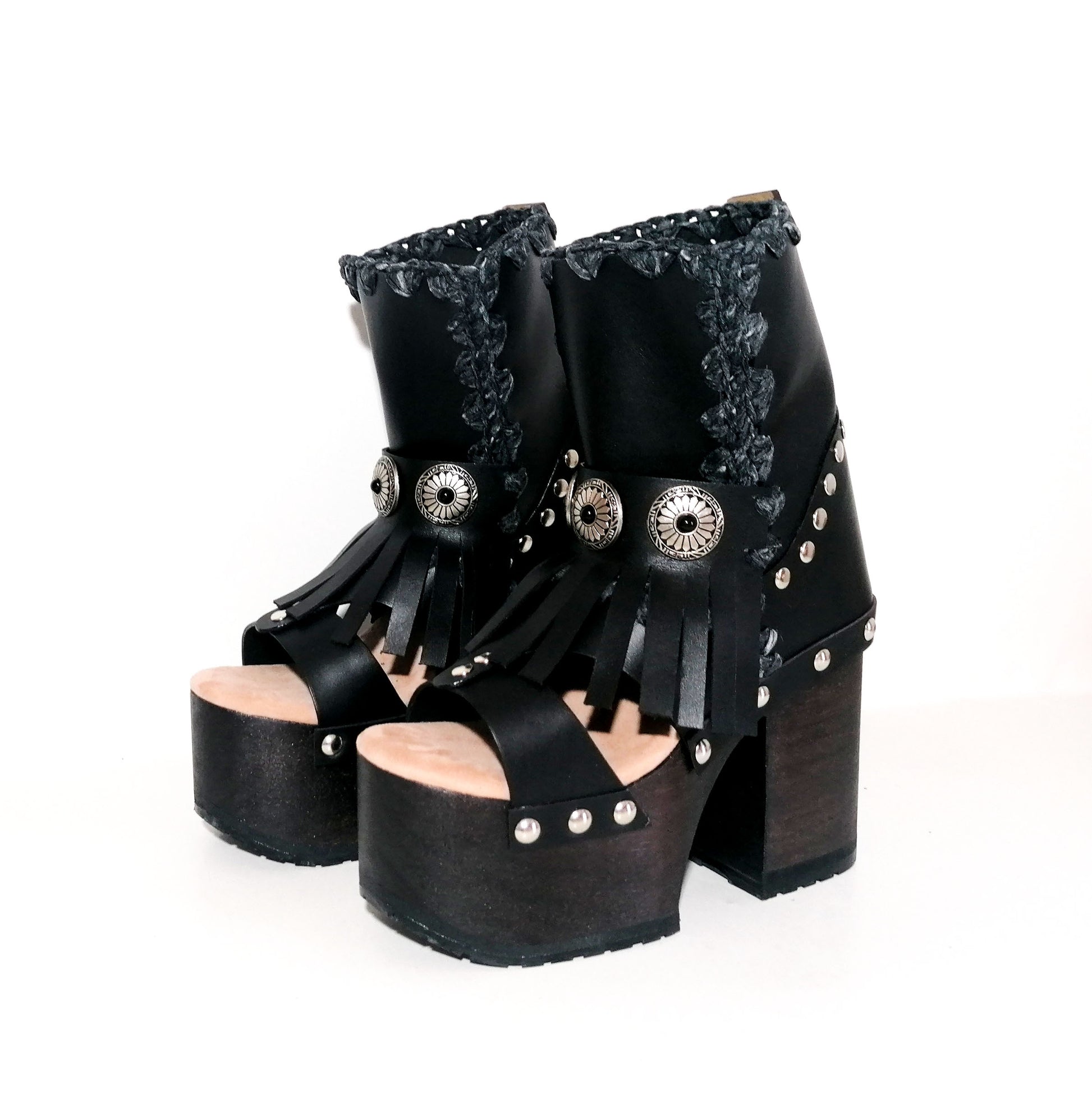 Black leather platform sandal. Leather boot with super high wooden heel. Black leather boot decorated with fringes and silver conchos. Bohemian style boots. Sizes 34 to 47. High quality leather shoes handmade by sol Caleyo. Sustainable fashion.