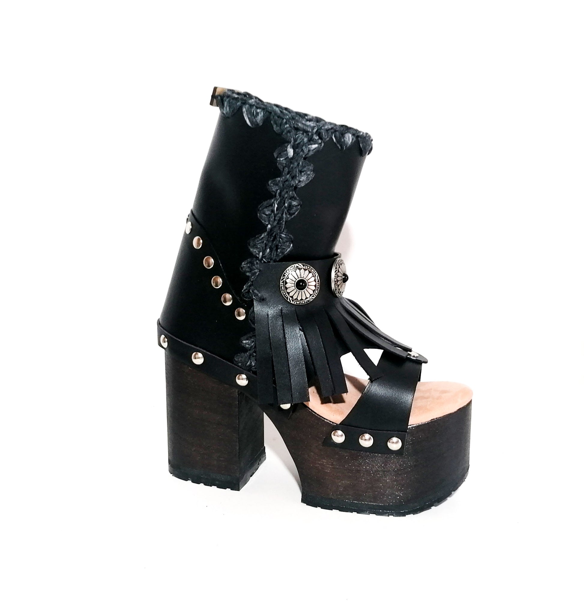 Black leather platform sandal. Leather boot with super high wooden heel. Black leather boot decorated with fringes and silver conchos. Bohemian style boots. Sizes 34 to 47. High quality leather shoes handmade by sol Caleyo. Sustainable fashion.