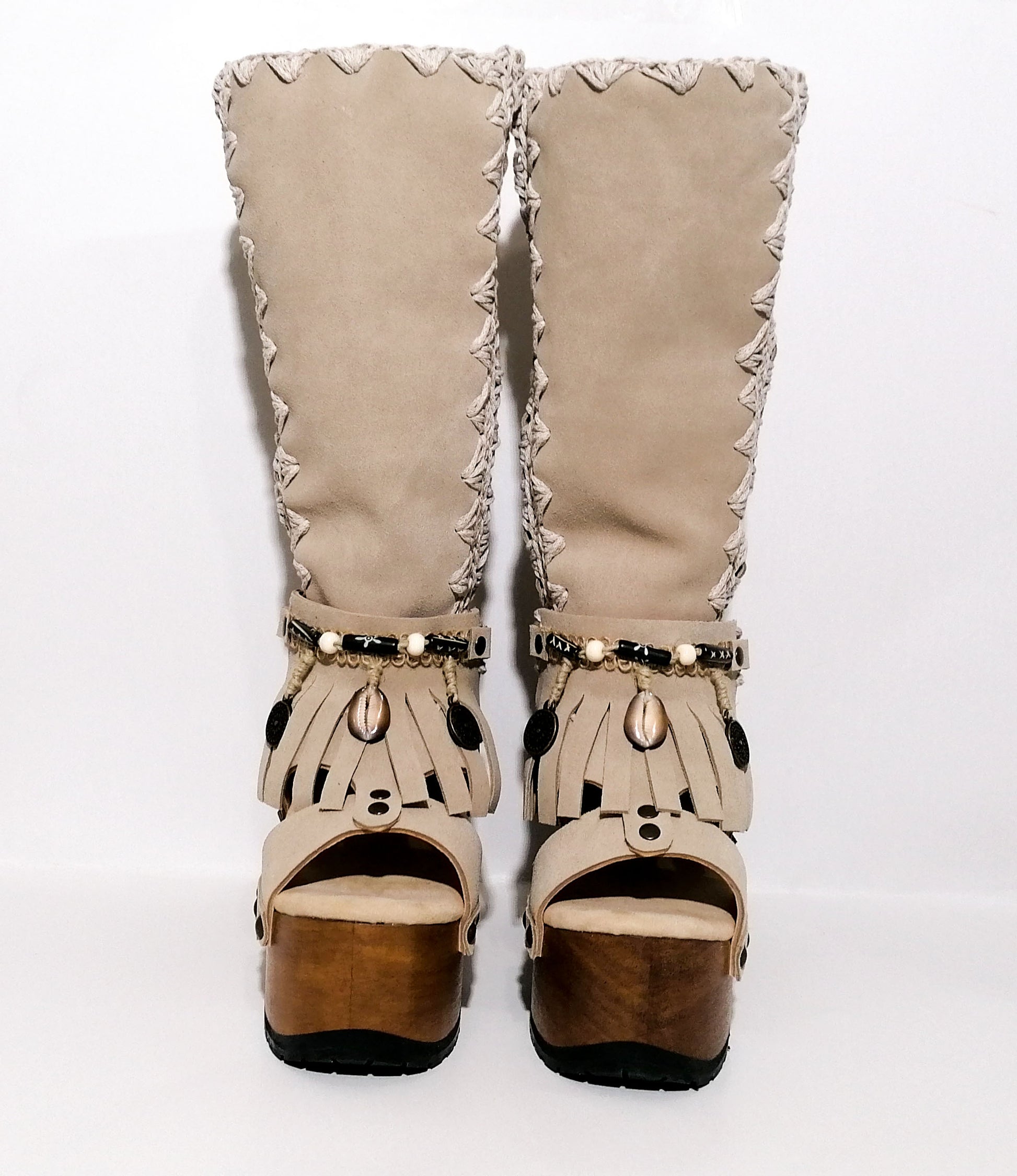 Vintage style wooden heeled clog boot. Suede leather boot decorated with fringes, natural shells, coins and carved bone with an authentic bohemian style. Boho style boots. Sizes 34 to 47. Handmade leather footwear by sol Caleyo.