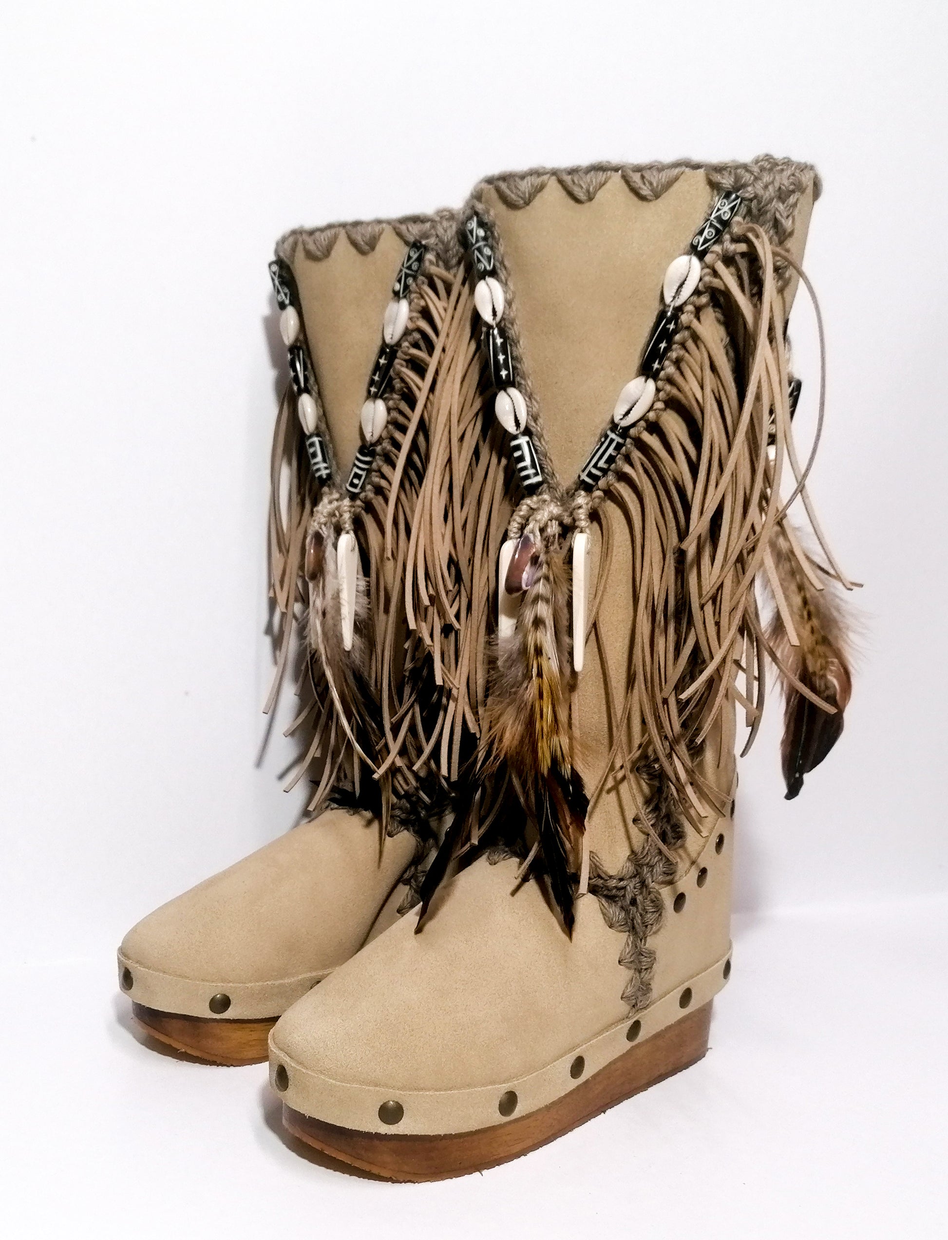 Wooden clog boot. Suede leather boot decorated with fringes, natural shells, feathers, horns and hand painted buffalo. Bohemian style boot with wooden wedge. Sizes 34 to 47. High quality leather footwear handmade by sol Caleyo. Sustainable fashion.
