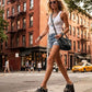 Blogger wearing Indian Snake Clogs with a white tank top and denim shorts, showcasing the 18cm platform height in an urban setting.