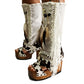 Handmade cowboy boots, white boots with cowhide and fringes. Cowboy style boots with hand painted buffalo, feathers, coins and natural shells. Vintage style platform boots. High-end leather footwear handmade by Sol Caleyo.