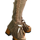 Bohemian-style boots in earth-colored suede leather. Bohemian-style platform boots, decorated with horns, fringes, feathers, and shells. High-end footwear handmade to order. Exclusive design by Sol Caleyo.