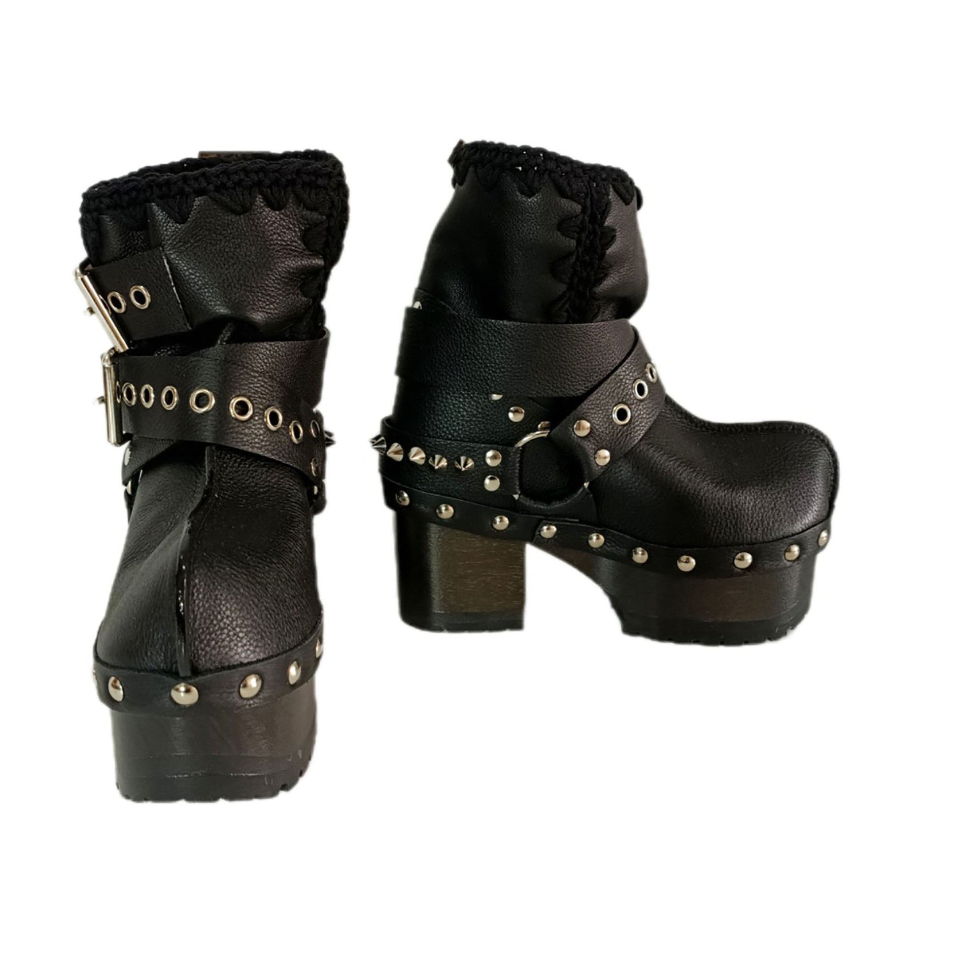 Black leather platform boots with silver studs. Black leather biker style boots with buckles. Black leather ankle boots with vintage style buckles. Leather boots with wooden heel. High-end handmade footwear by Sol Caleyo.