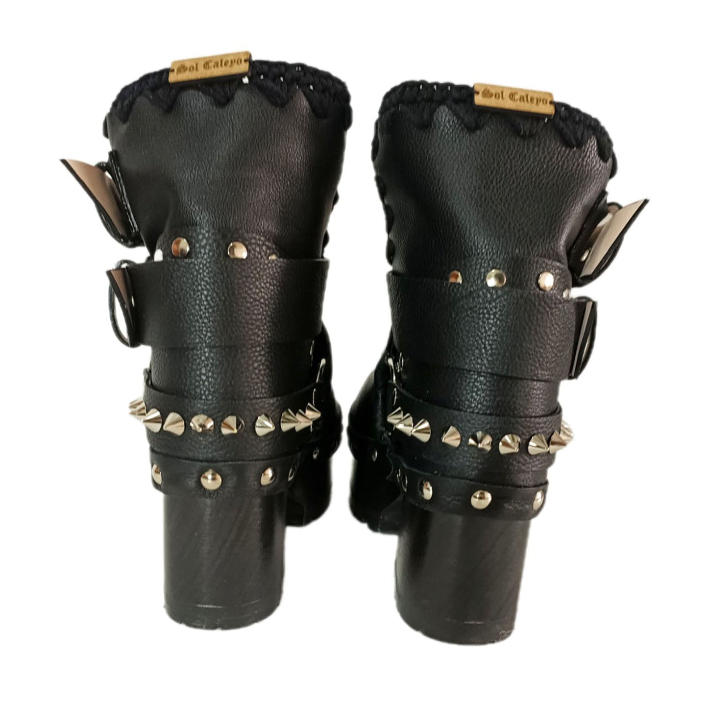 Black leather platform boots with silver studs. Black leather biker style boots with buckles. Black leather ankle boots with vintage style buckles. Leather boots with wooden heel. High-end handmade footwear by Sol Caleyo.