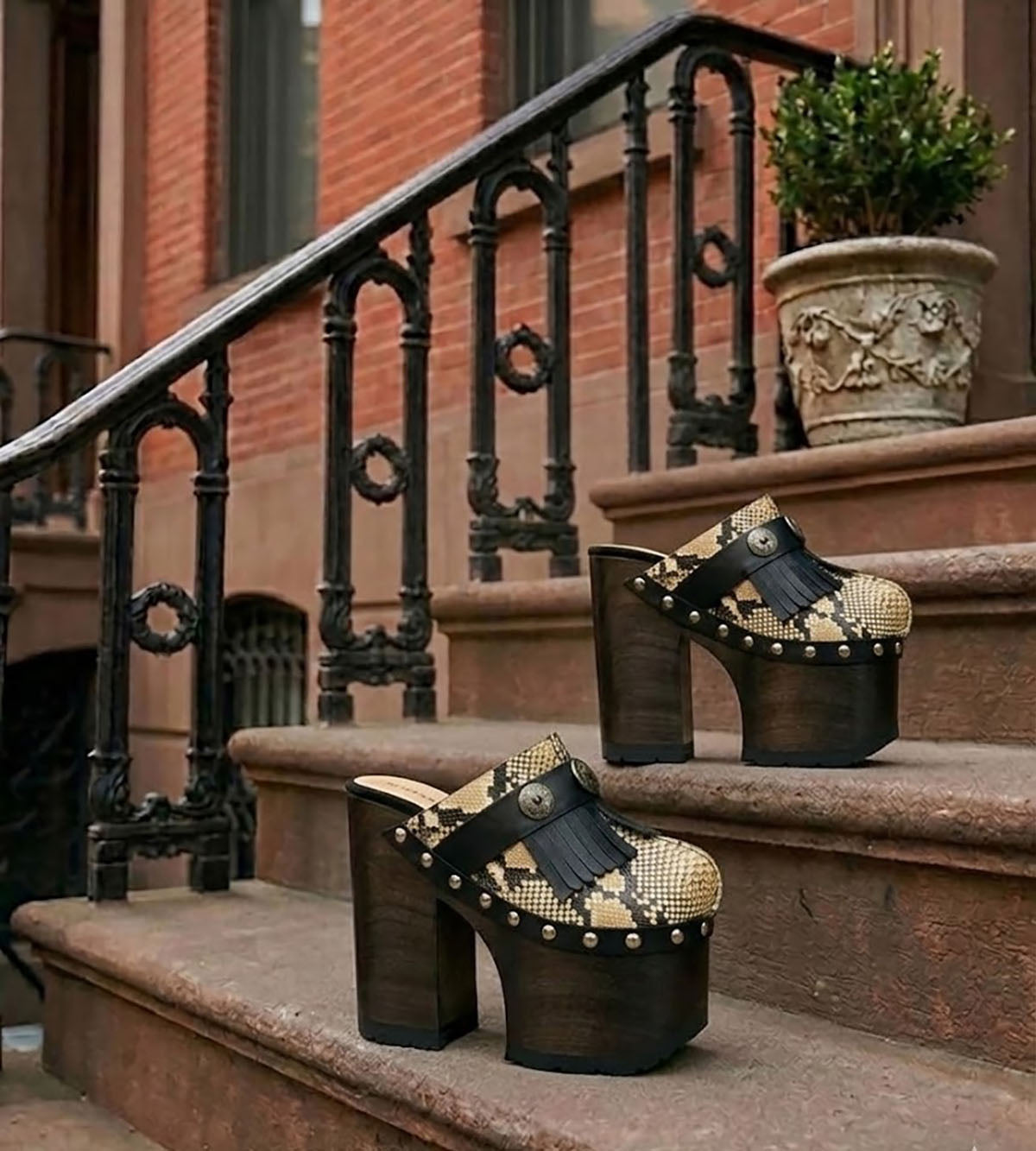 Indian Snake Clogs by Sol Caleyo: extreme 18cm straight heel wooden platforms with snake-print leather, black fringe, and Native American style metal conchos.