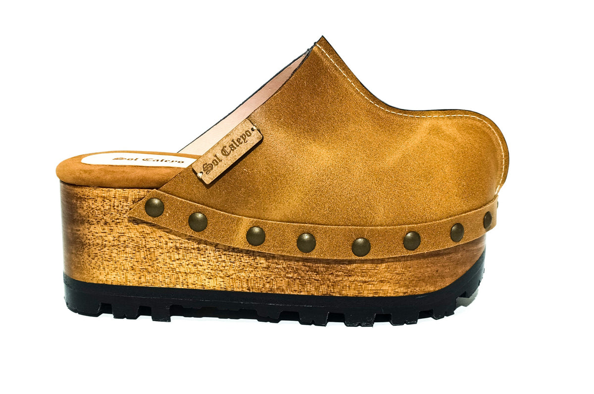 Aged camel handmade leather wedge mule clogs with antique-gold studs and 7 cm wooden wedge by Sol Caleyo.