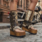 Model wearing Alabama Flip Flops Snake Boots with exotic snake-print leather, featuring a boho-chic luxury style with gold pyramid studs and high platform wedges.