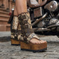 Model wearing Alabama Flip Flops Snake Boots with exotic snake-print leather, featuring a boho-chic luxury style with gold pyramid studs and high platform wedges.