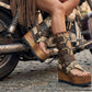 Model wearing Alabama Flip Flops Snake Boots with exotic snake-print leather, featuring a boho-chic luxury style with gold pyramid studs and high platform wedges.