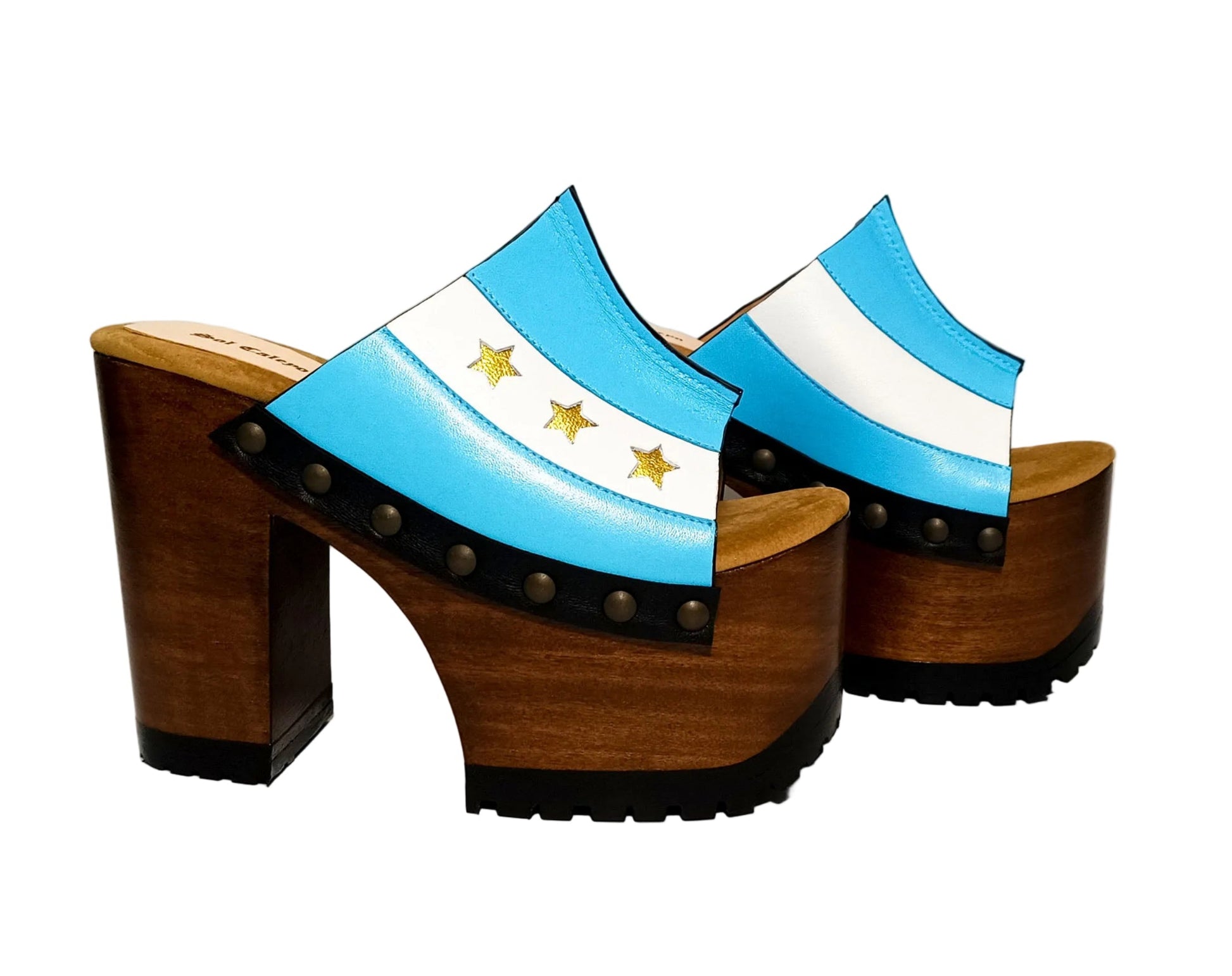 Pair of Sol Caleyo Argentina Sandals featuring a handcrafted wooden block heel and platform, a blue and white leather strap designed as the Argentine flag with three gold stars, and antique gold studs.