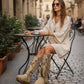 Handmade beige split suede closed-toe wedge boots with hand-painted buffalo on the back, V-shaped fringe, natural feathers, horns, shells and 5 cm natural lacquered wooden wedge by Sol Caleyo.