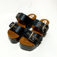 Handmade black leather buckle wedge sandals with silver studs and 6 cm wenge wooden wedge by Sol Caleyo.