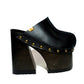 Handmade smooth black leather closed-toe mule clogs with old-gold studs and 16 cm wenge lacquered bell-shaped wooden heel by Sol Caleyo.