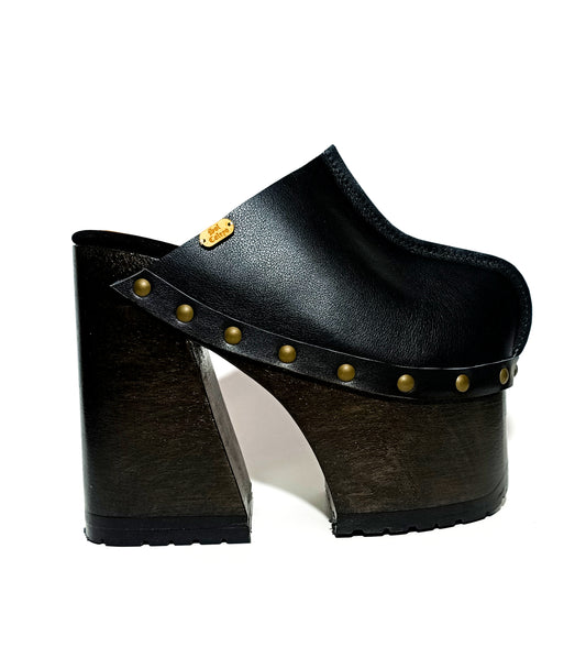 Handmade smooth black leather closed-toe mule clogs with old-gold studs and 16 cm wenge lacquered bell-shaped wooden heel by Sol Caleyo.