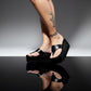 Handmade smooth black leather wedge flip flop sandals with round flat silver studs and 8 cm wenge lacquered wooden wedge by Sol Caleyo.