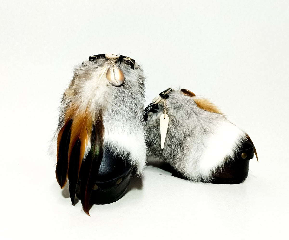 Handmade smooth black leather closed-toe platform mule clogs with chinchilla rabbit fur, feathers, bone, carved horn, shells and 6 cm wenge lacquered wooden heel by Sol Caleyo.