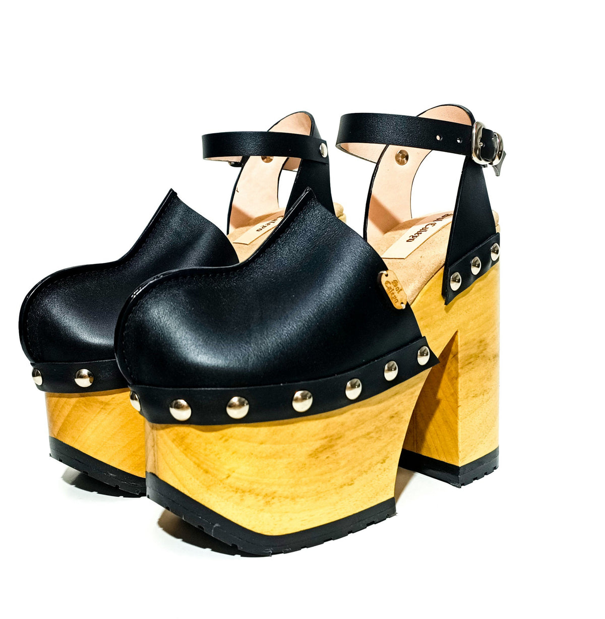 Handmade black leather Mary Jane platform clogs with adjustable silver buckle strap, studs and 14 cm wooden heel by Sol Caleyo.