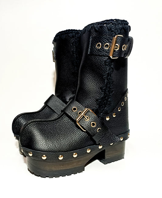 Handmade smooth black leather mid-calf platform boots with silver buckles, rivets and 6.5 cm wenge lacquered wooden heel by Sol Caleyo.