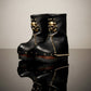 Handmade smooth black leather mid-calf wedge boots with old-gold metal skull, pyramid studs and 8 cm wenge lacquered wooden wedge by Sol Caleyo.