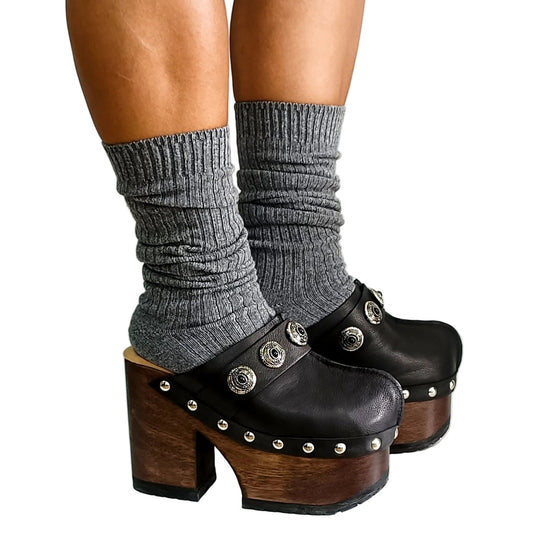 Handmade smooth black leather closed-toe platform mule clogs with five carved conchos on the instep strap, round flat silver studs and 12 cm straight wenge lacquered wooden heel by Sol Caleyo.