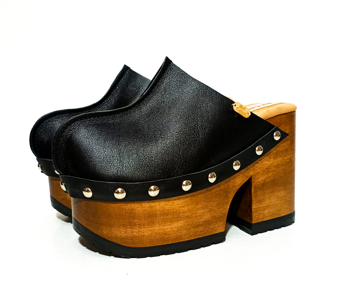 Handmade black leather closed-toe platform mule clogs with round flat silver studs and 12 cm straight natural lacquered wooden heel by Sol Caleyo.