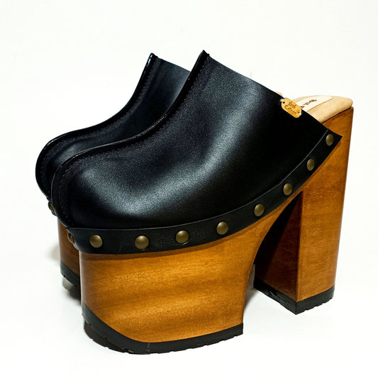 Antique-gold studs on black leather platform mule clogs, Wooden platform 17 cm heel with lacquer, Tractor rubber outsole on 10 cm platform, Suede kidskin insole.