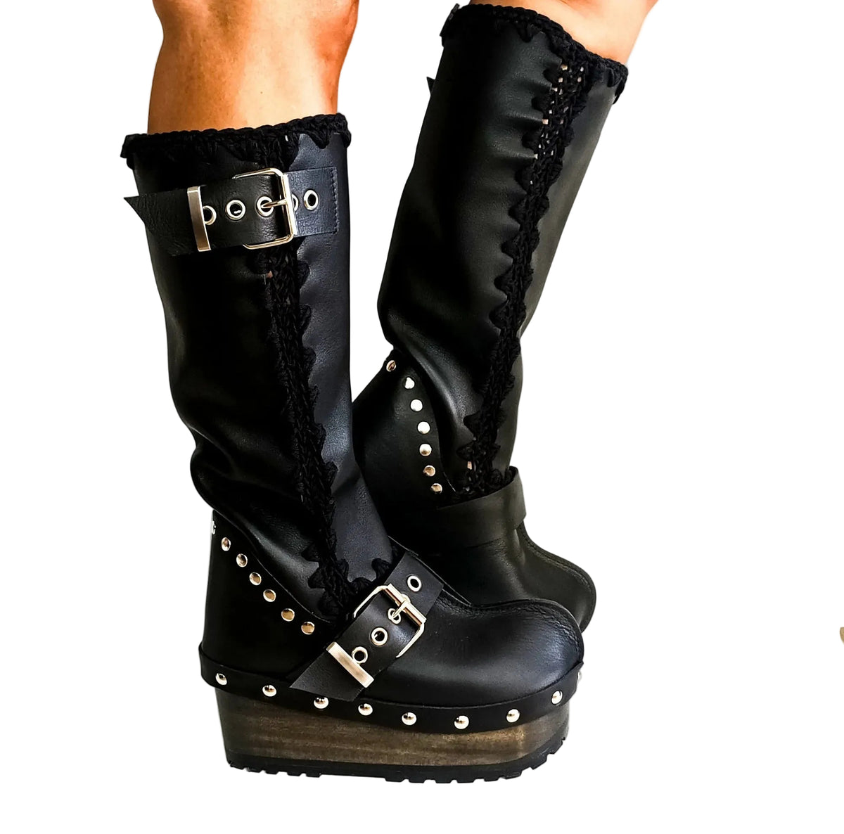 Handmade smooth black leather tall wedge boots with silver biker buckles and 8 cm wenge lacquered wooden wedge by Sol Caleyo.