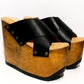 Handmade black leather wedge mule sandals with round flat old-gold studs and 15 cm natural lacquered wooden wedge by Sol Caleyo.