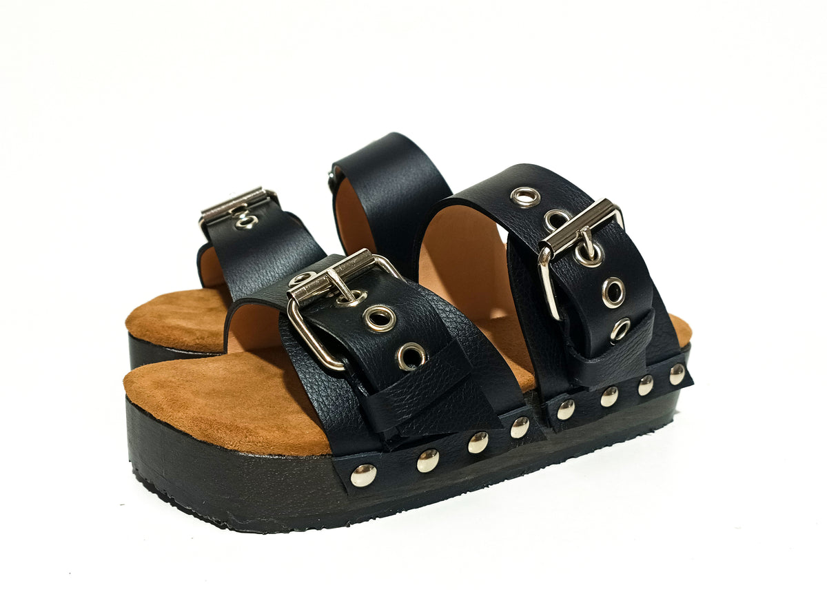 Handmade black leather low wedge sandals with silver buckles, eyelets and 3 cm wenge wooden wedge by Sol Caleyo.
